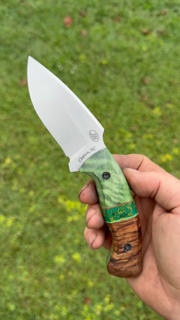 Josh's broad polished blade with a green figured grip, a green-and-gold accent band and a brown figured handle end